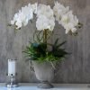 Artificial orchid centerpiece in urn vase