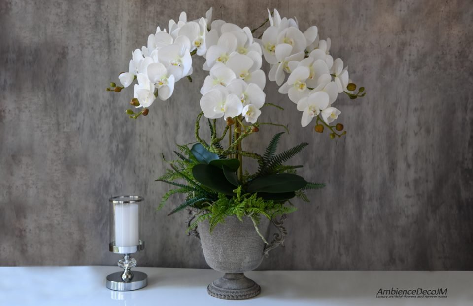 Artificial orchid centerpiece in urn vase