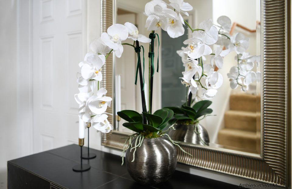 Orchids in a silver metal bowl