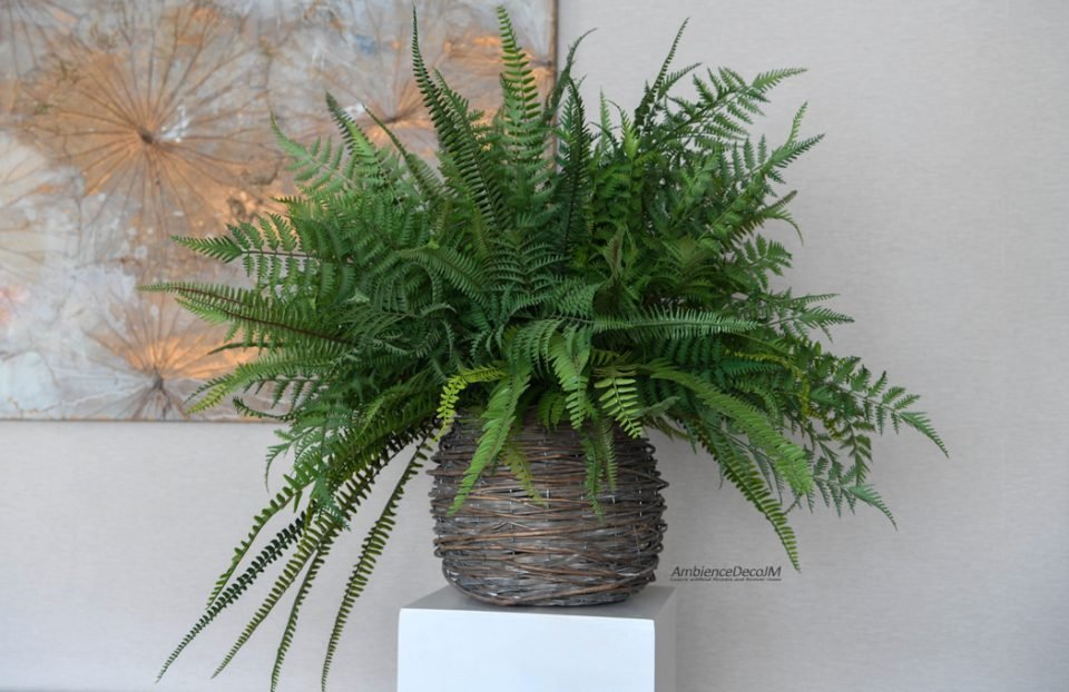 Large artificial mixed fern arrangement with lush green foliage in a rustic woven basket