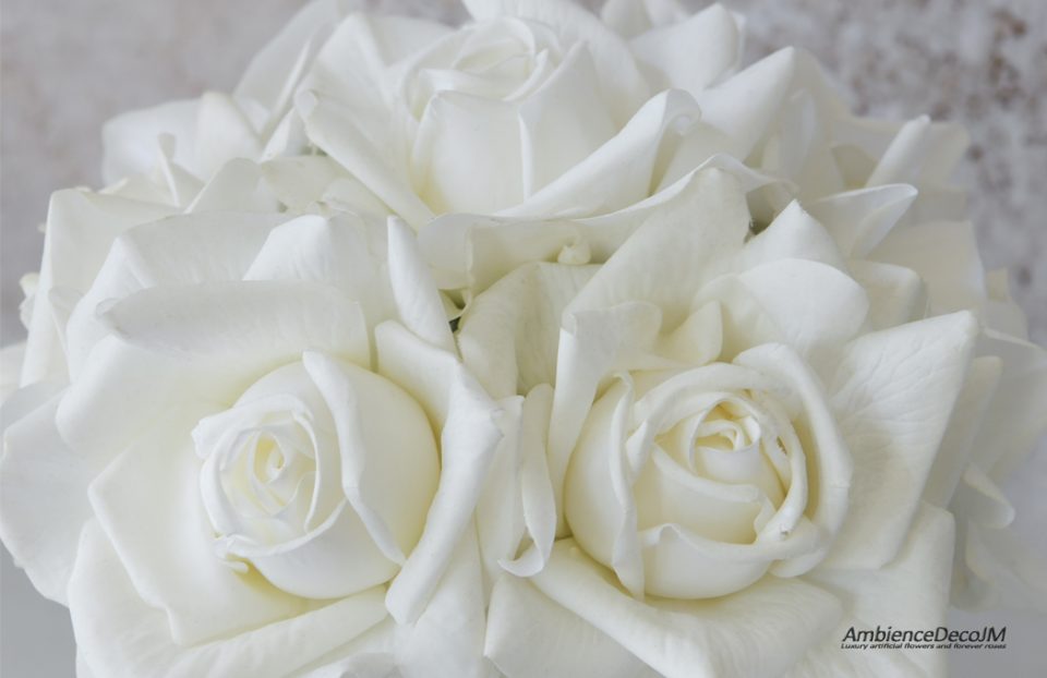 Real touch white roses in a vase