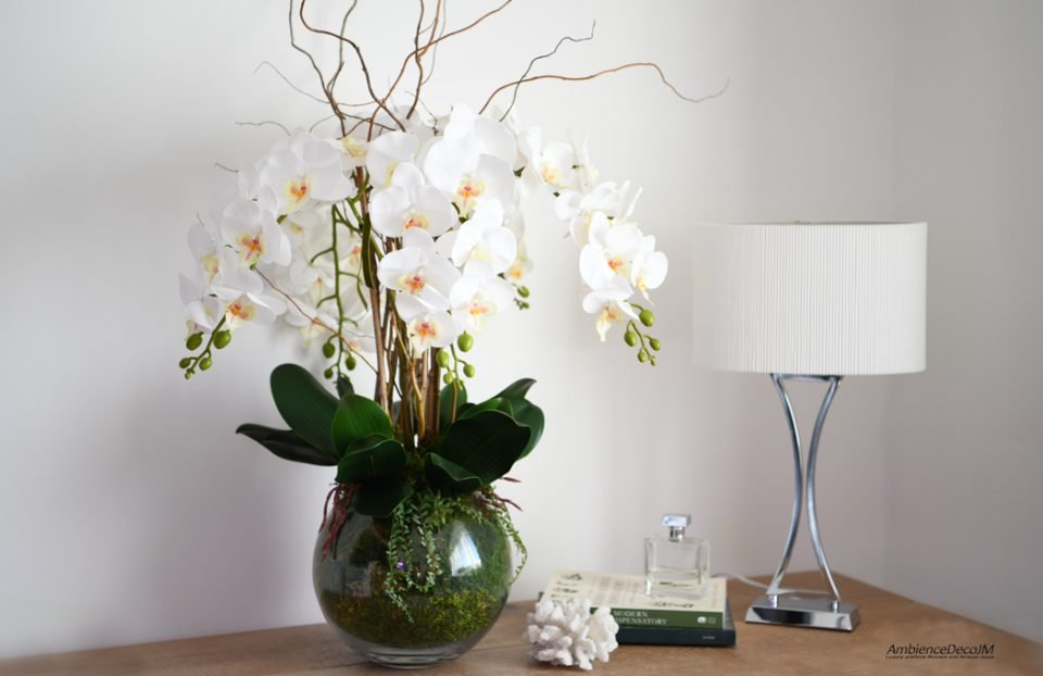 Orchid arrangement in fishbowl with moss