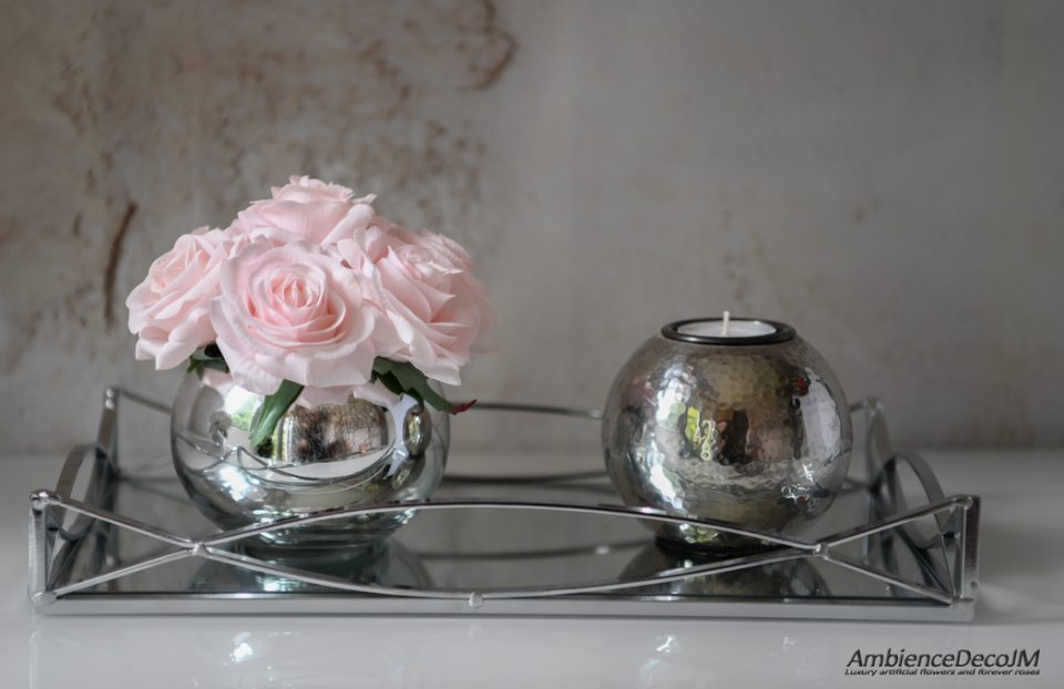 Artificial flowers in a glass vase.