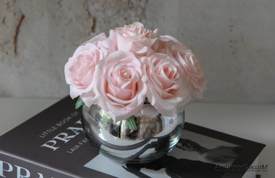 Artificial flowers in a glass vase.