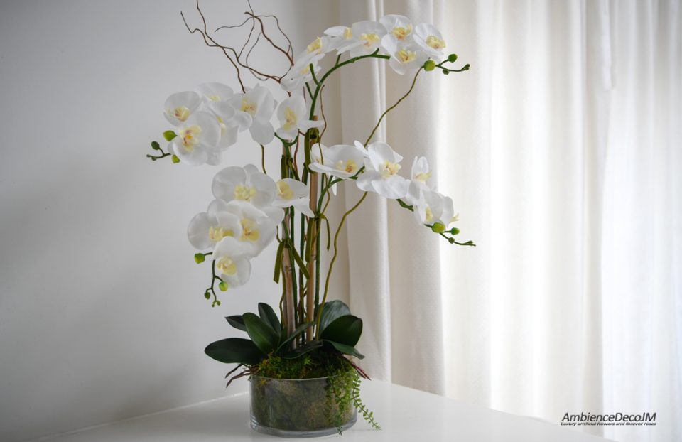 Faux orchids in a glass bowl