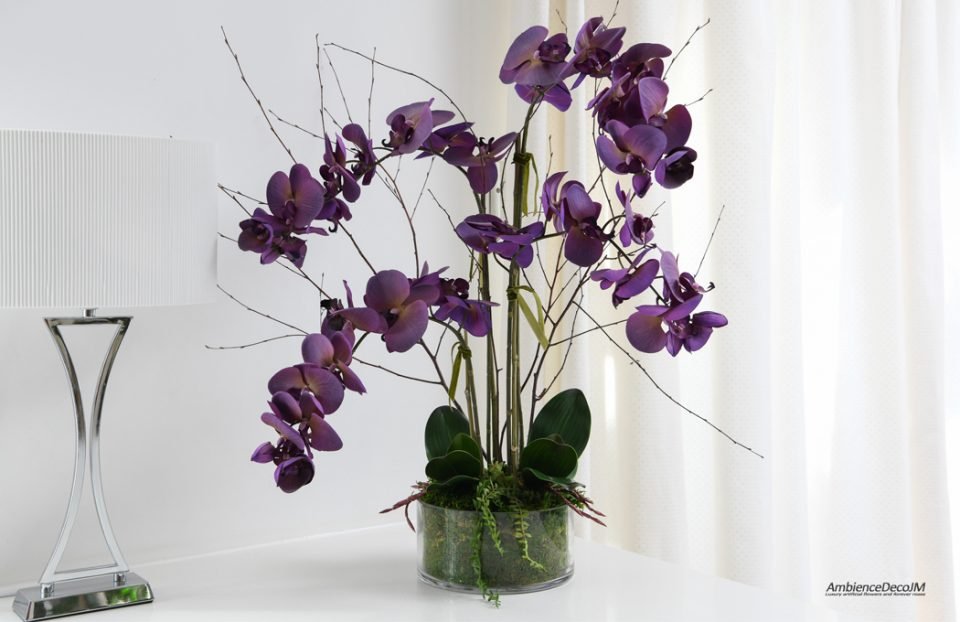 Purple orchids in a glass dish