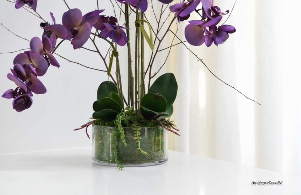 Purple orchids in a glass dish