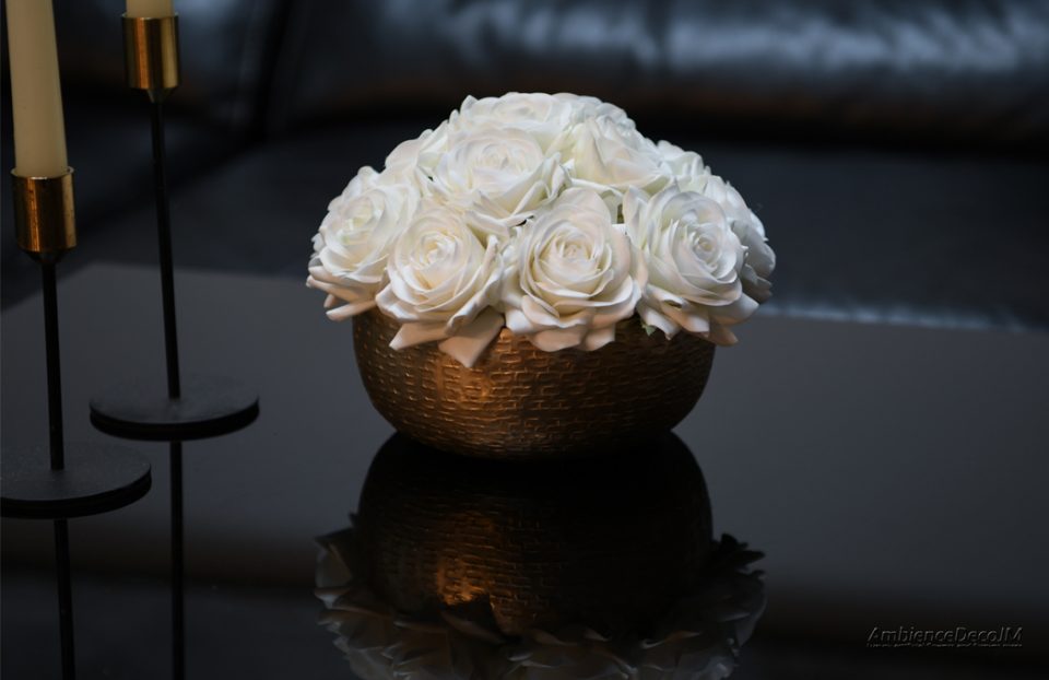 Artificial roses in a dish vase