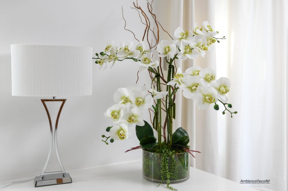 Realistic orchids in a glass bowl