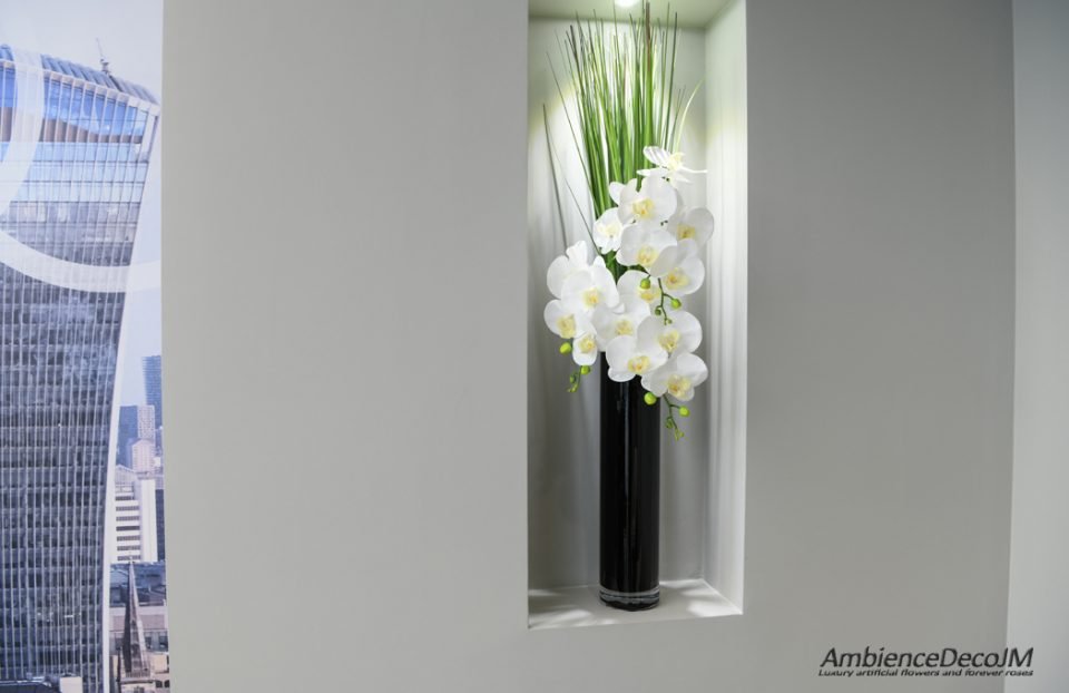 Orchids in glass cylinder