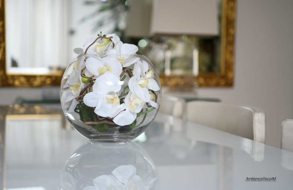 Orchids in a fishbowl vase