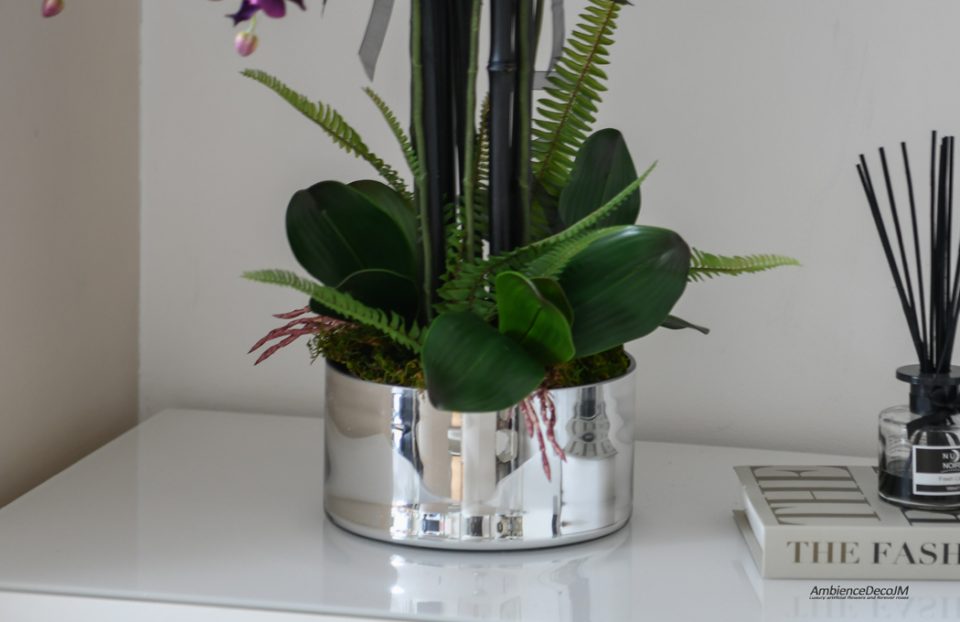 Purple Orchid arrangement in a silver vase