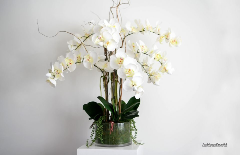 Silk orchid arrangement in moss bowl